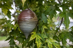 ceramic sculpture in tree