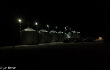 Row of grain bins at night,