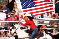 Bailey Stoddard carries the colors Sturday evening at WCF Rodeo